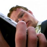 504653_businessman_looking_at_his_pda